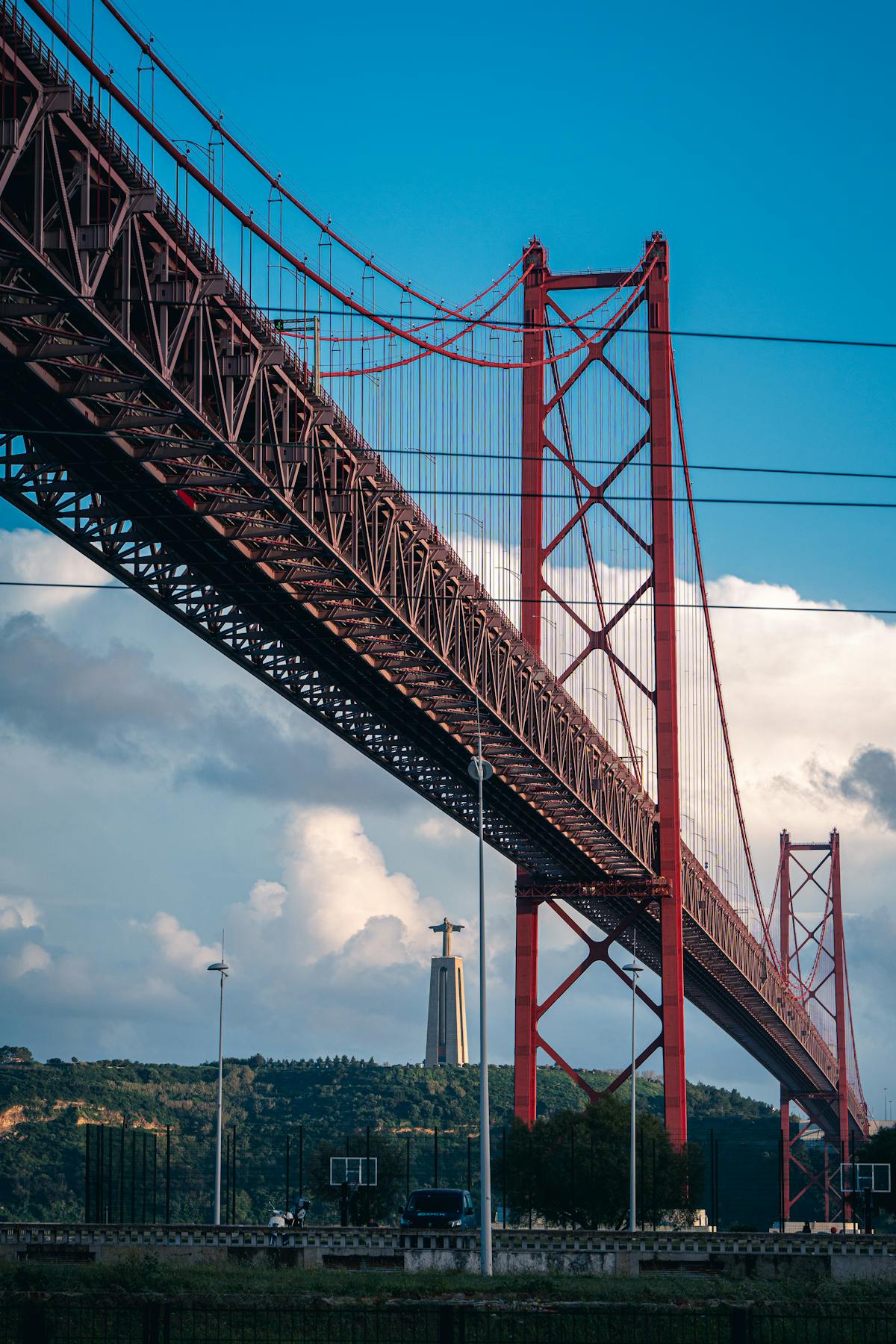 The 25 de Abril Bridge spanning the Tagus River with Cristo Rei statue in the background