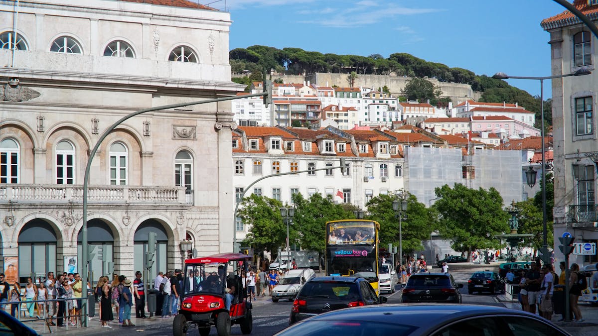 A lively street in central Lisbon with historic buildings and pedestrians