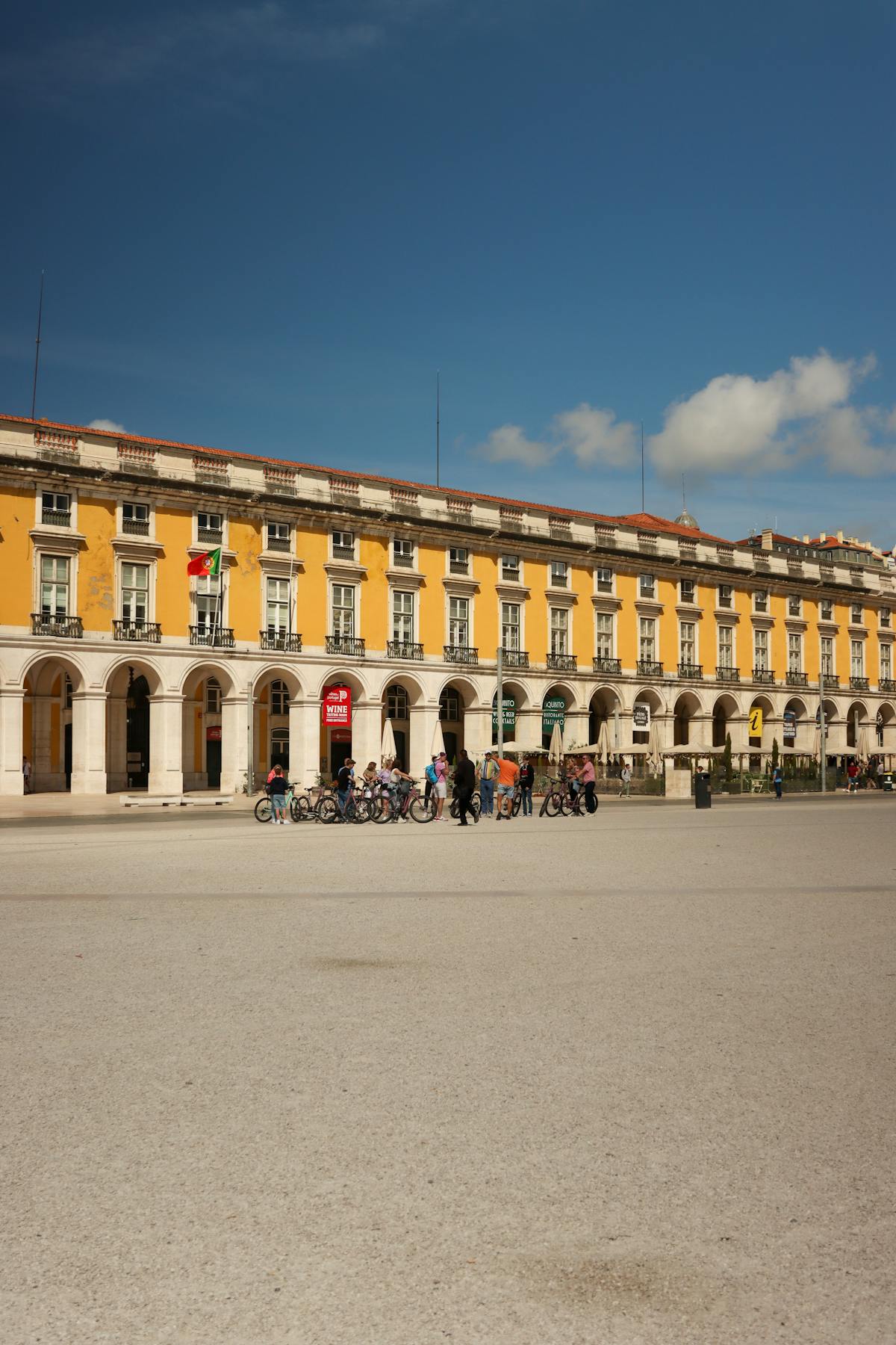 A sunny day at Praca do Comercio in Lisbon with yellow buildings