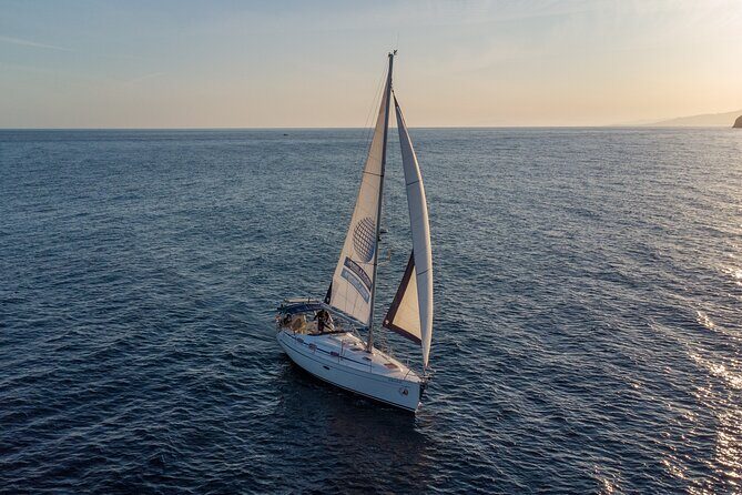 Sailing at sunset along the cliffs of Maro-Compartida - An In-Depth Look at the Sunset Sailing Experience