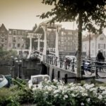 Amsterdam: Guided City Bike Tour in French - The Detailed Ride Through Amsterdam