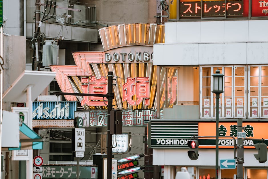 Street signs and vibrant city life in Dotonbori, O