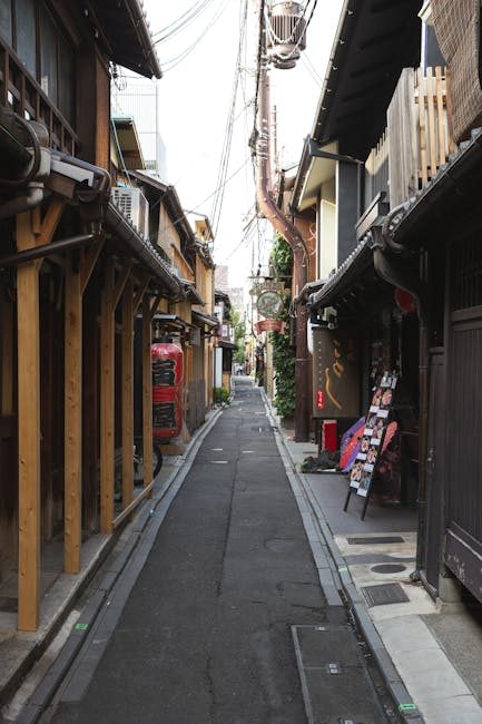 Explore a quiet, narrow street in Kyoto showcasing traditional architecture and local charm.