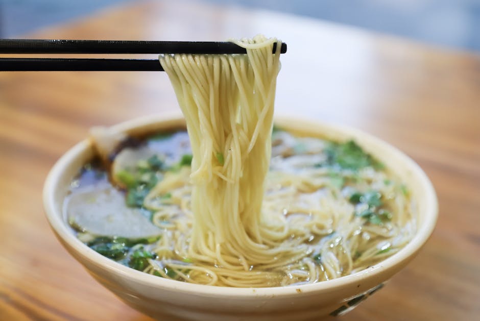 Savor the mouthwatering taste of fresh ramen noodles lifted by chopsti