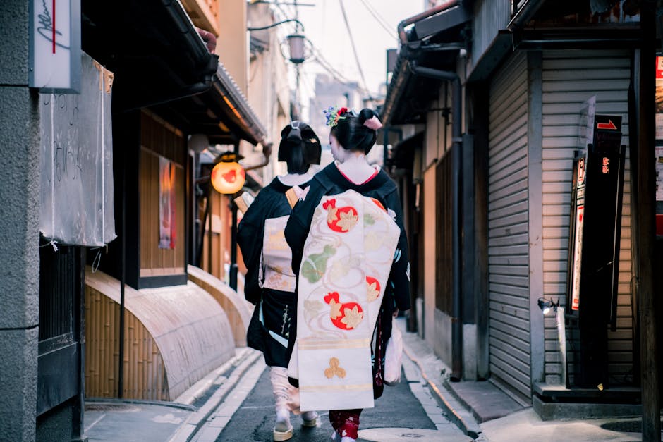 Elegant Japanese women in kimonos walking through a Kyoto al