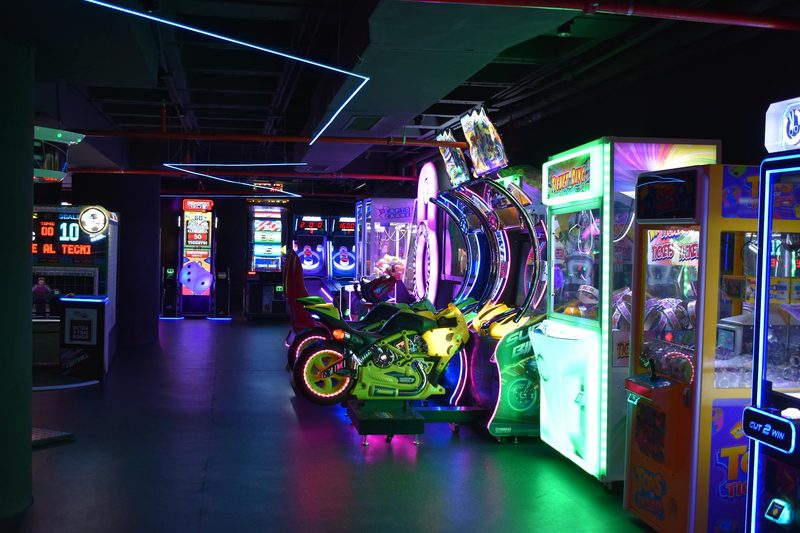 Colorful neon-lit arcade filled with gaming machines
