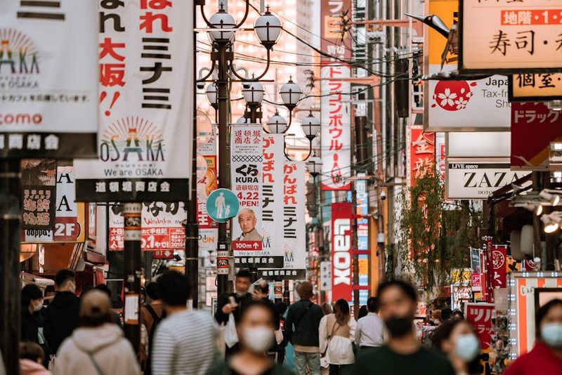 Vibrant street view of downtown Osaka, showcasing urban life and colorful signs.