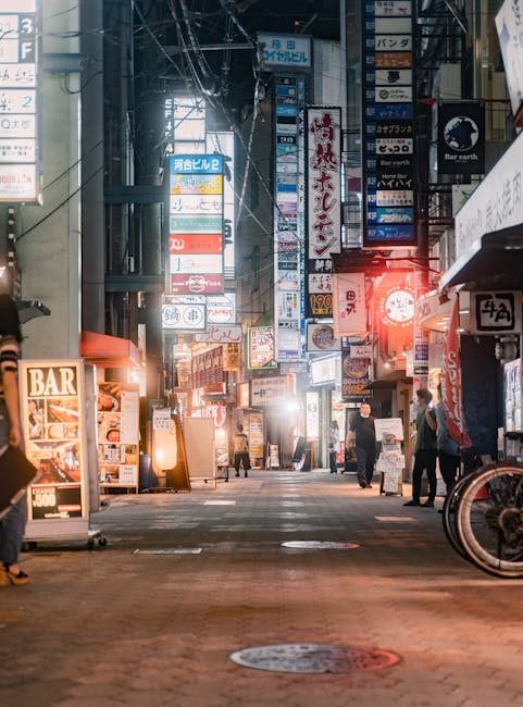 Experience the bustling nightlife in downtown Osaka, with vibrant signs and lively streets.