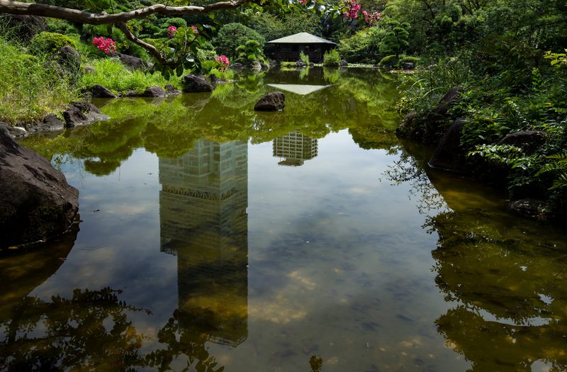 Abeno Harukas tower reflected in Keitakuen garden pond, Osaka