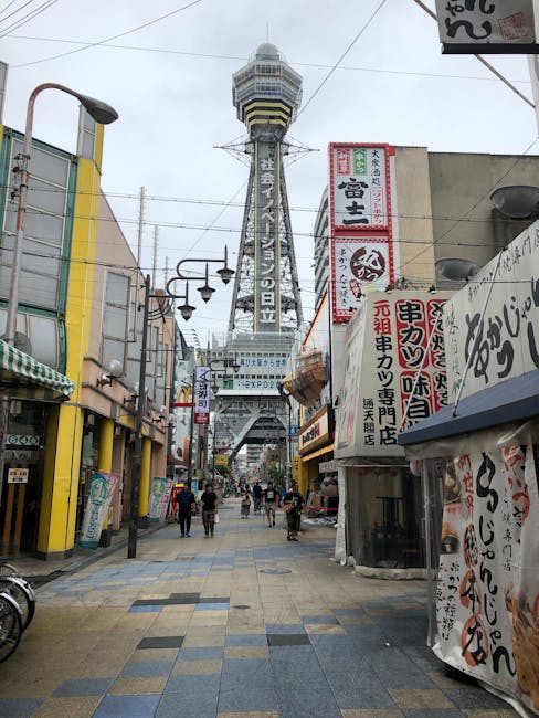 Stroll through bustling Namba in Osaka, Japan, with iconic Tsūtenkaku Tower soaring above.