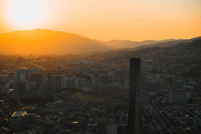 A beautiful sunset over the skyline of Ikeda, Osaka, Japan, highlighting cityscape and mountains.