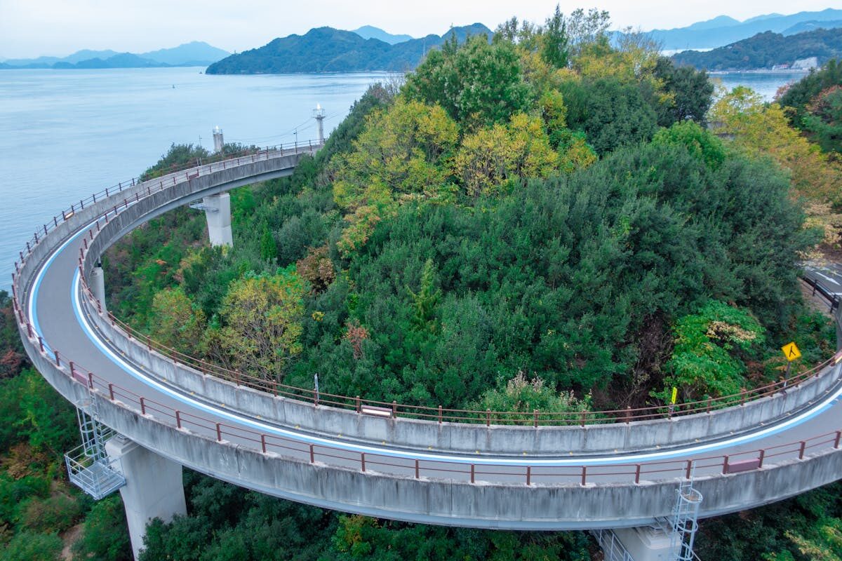 Aerial view of the Shimanami Kaido winding through green islands above the Seto Inland Sea