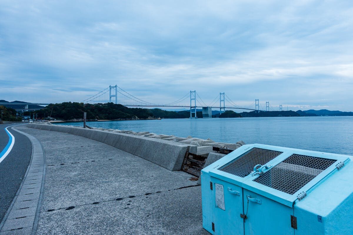 Long cable-stayed bridge stretching over the calm blue waters of the Seto Inland Sea near Onomichi