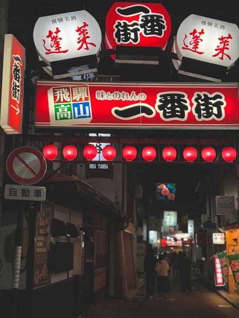 Vibrant Takayama street at night with glowing lanterns and urban ambiance.