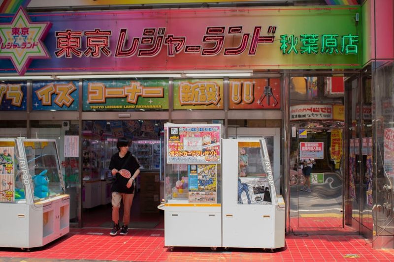 Entrance of Tokyo Leisureland arcade in Akihabara, showcasing gaming machines and vibrant signs.