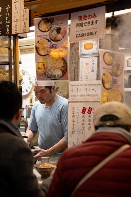 Street food vendor preparing traditional dishes in bustling Shinjuku, Tokyo izakaya.