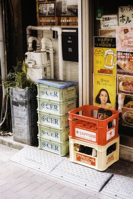Urban street corner in Tokyo with stacked beverage crates and vibrant posters.