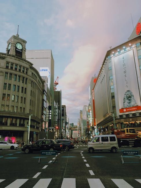 Vibrant urban scene in Chuo City, Tokyo with traffic and iconic buildings at dusk.