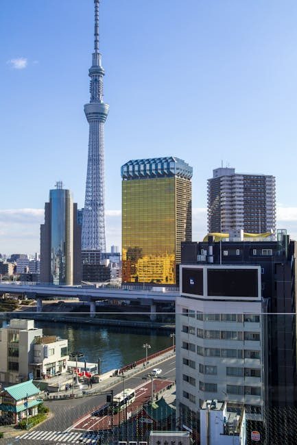 Stunning view of Tokyo Skytree with city buildings and Sumida River on a clear day.