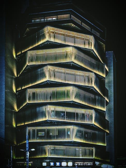 Captivating night view of a modern illuminated building facade in Tokyo, Japan.