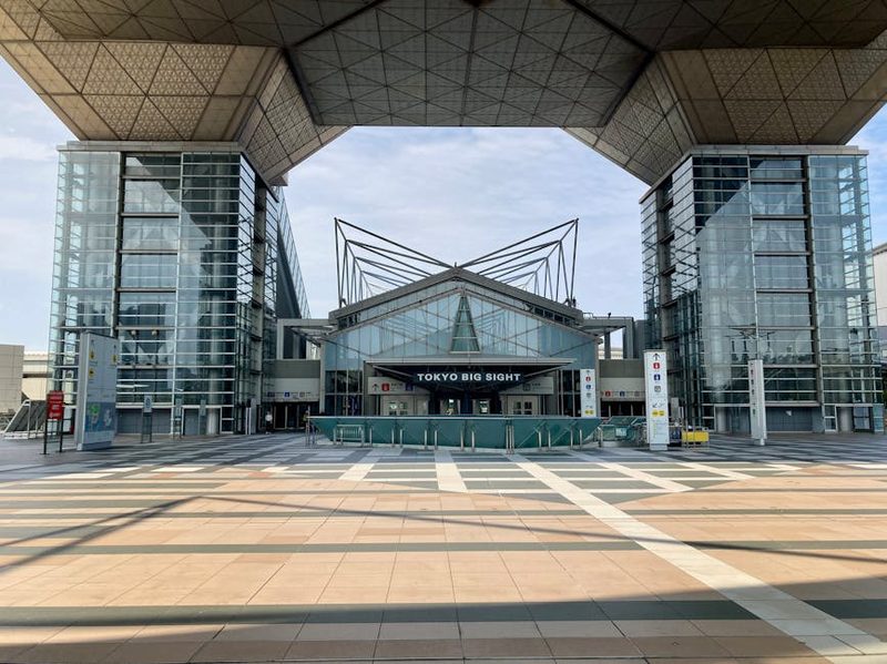 Front view of Tokyo Big Sight convention center entrance in Odaiba, Tokyo, showcasing modern architecture.