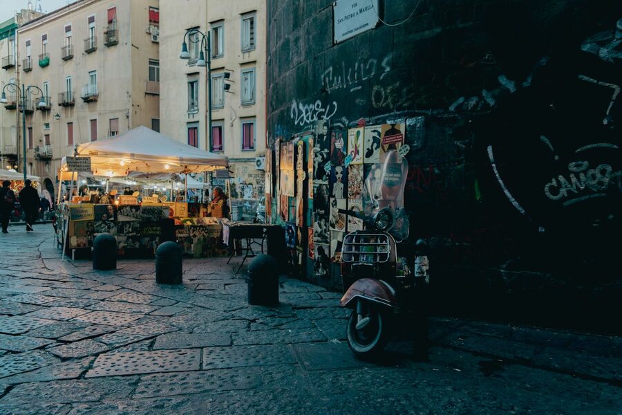 Evening street scene in the historic centre of Naples with shops and pedestrians