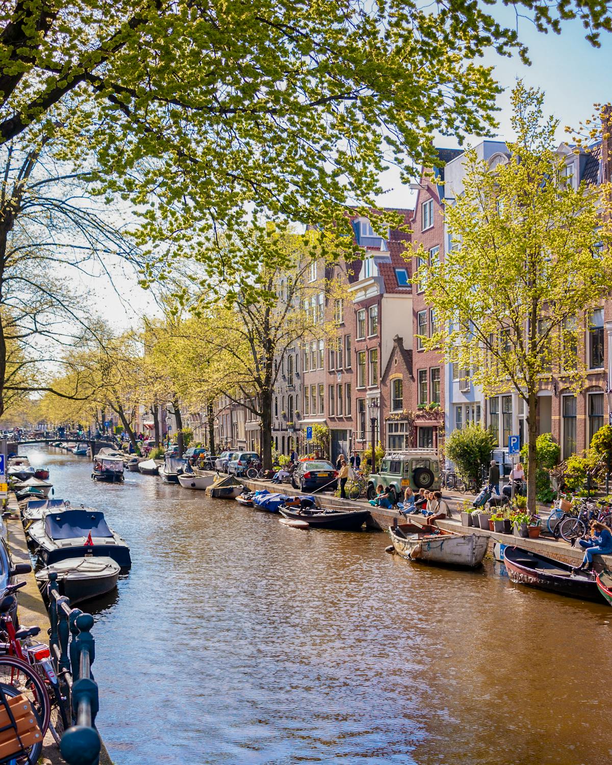 Amsterdam canal lined with boats and classic Dutch architecture