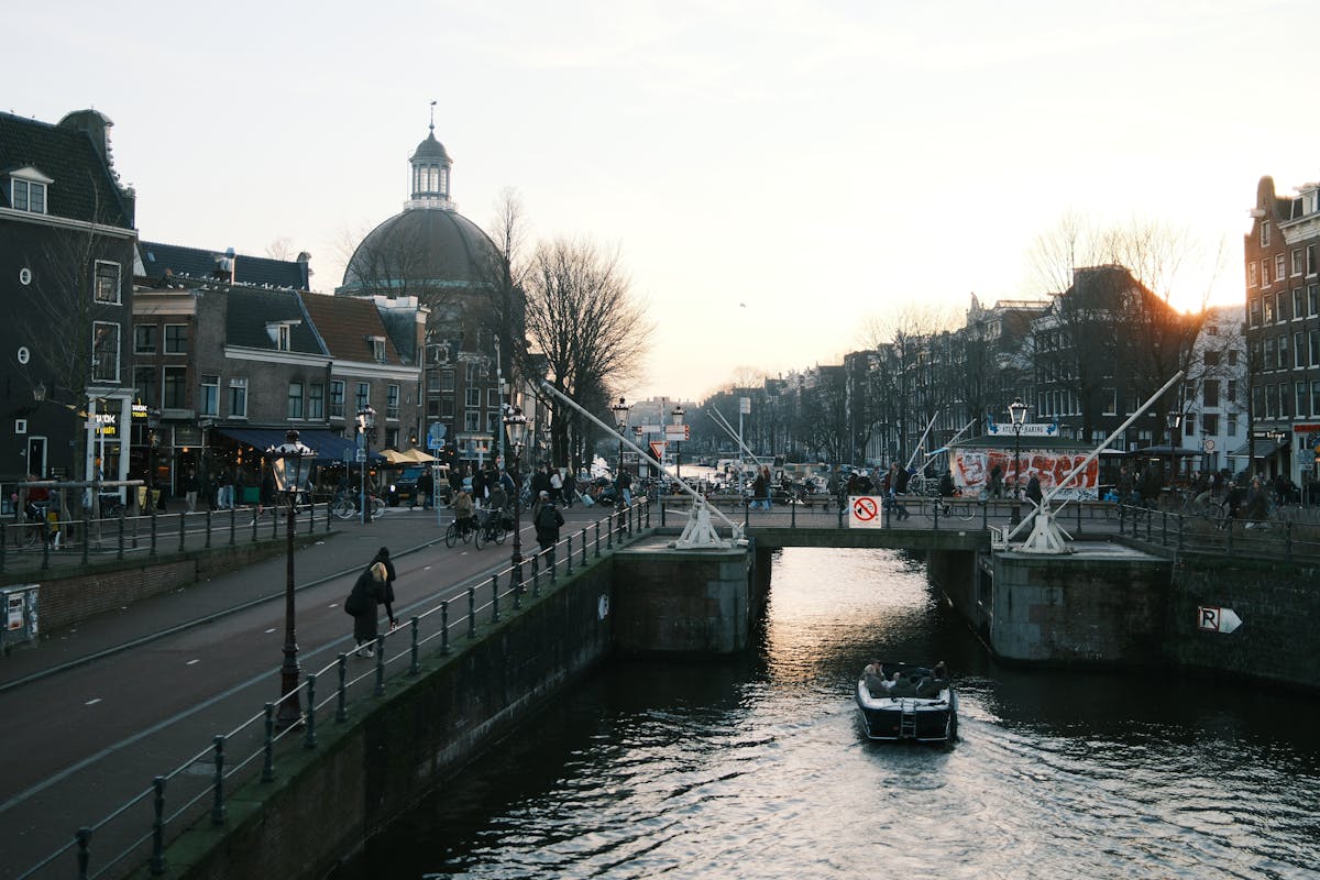 Historic Amsterdam bridge and canal at golden hour