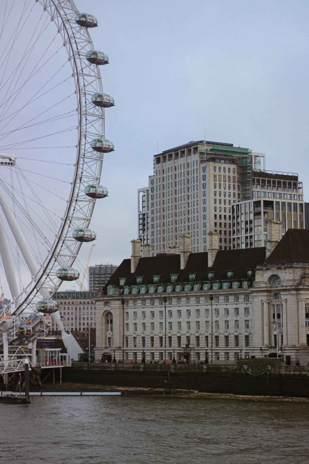 The London Eye along the River Thames with city architecture