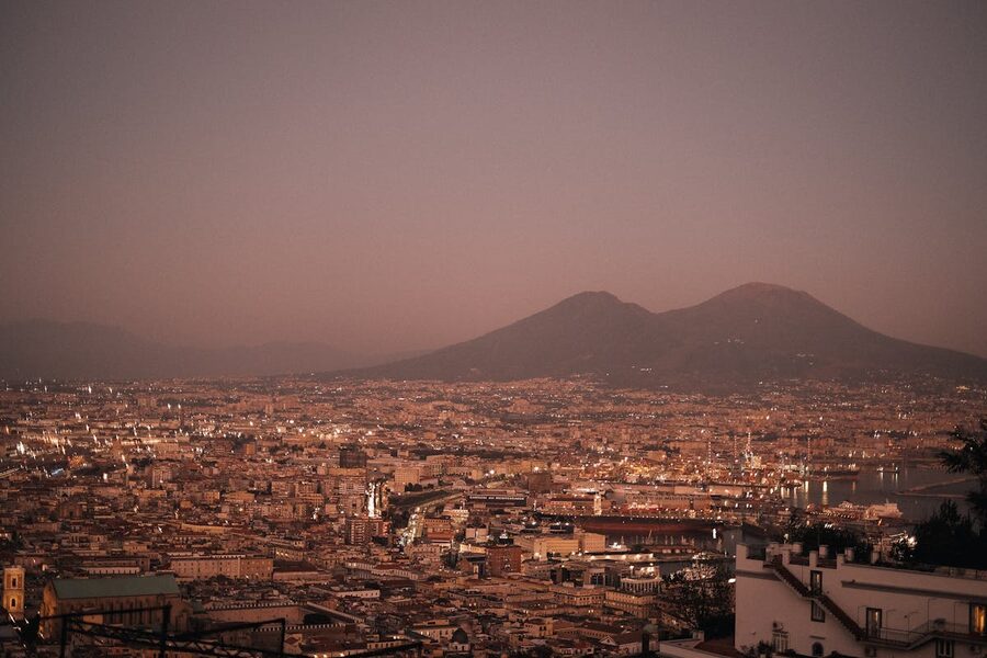 Sunset view over Naples cityscape with Mount Vesuvius in the distance