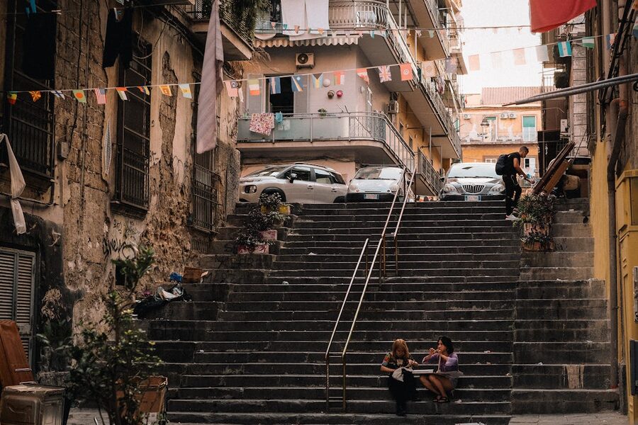 People walking on city stairs in Naples historic centre