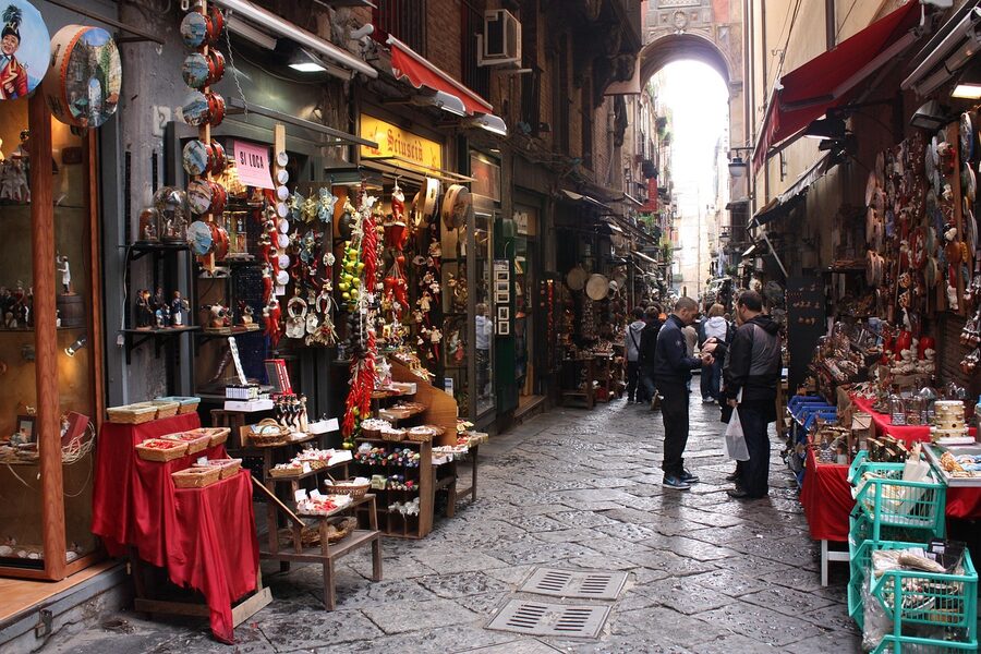 Spaccanapoli street in Naples with shops, markets and travelers