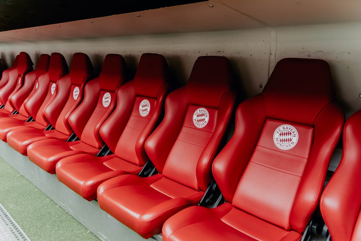 Bright red stadium seats in rows inside a modern football arena