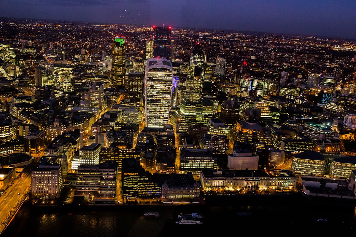 Aerial view of London at night with the city illuminated