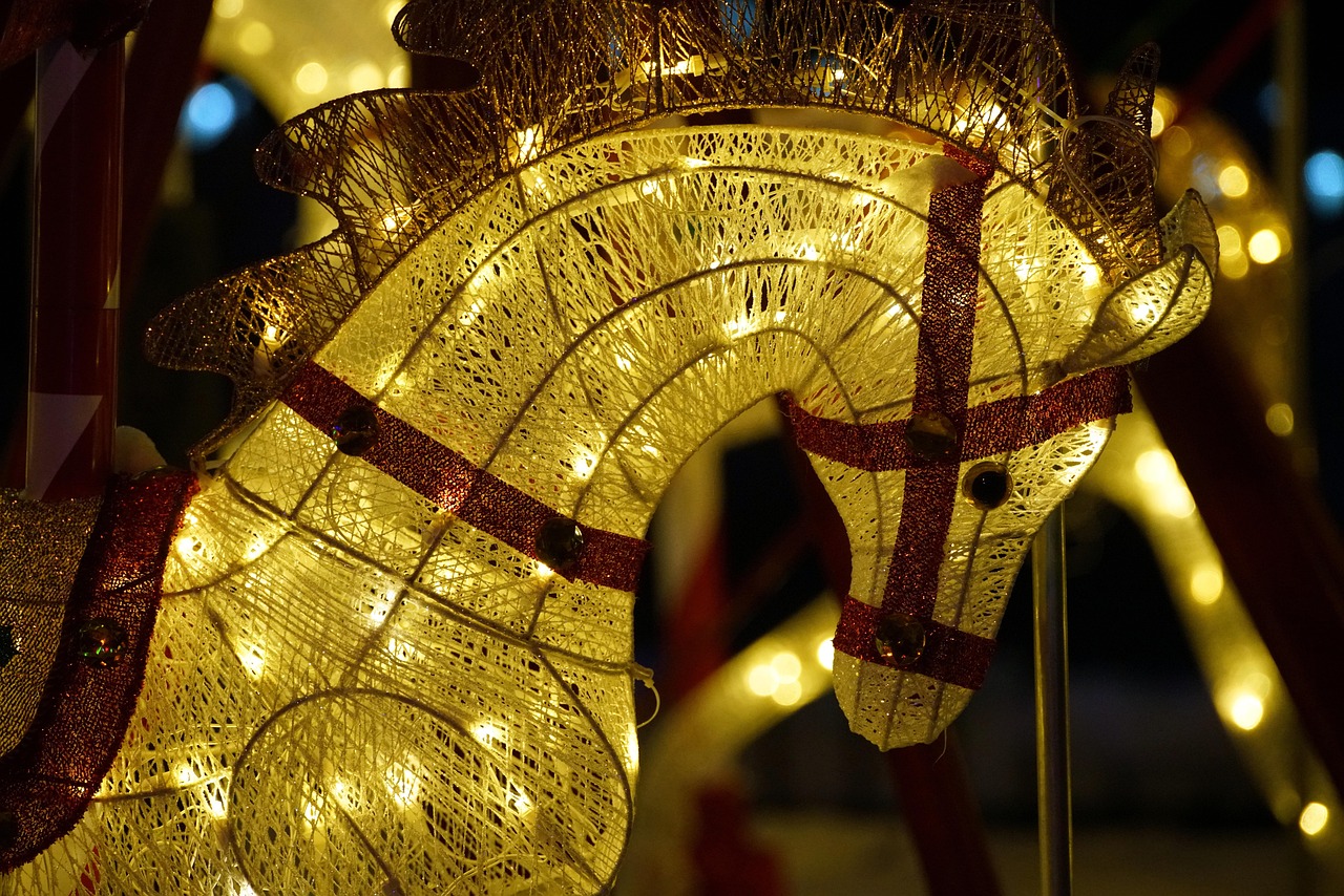 Brightly lit carousel at night with ornate decorations