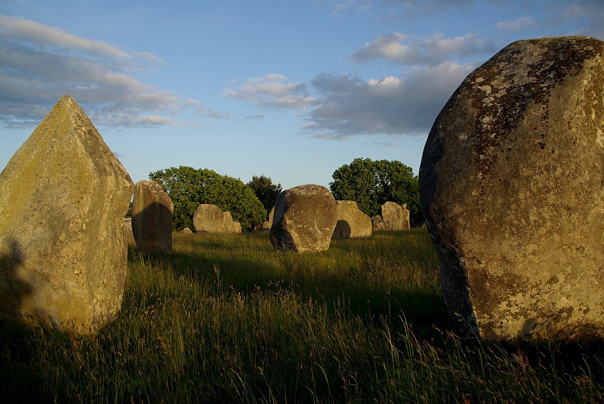 Neolithic standing menhirs in a green field near Carnac Brittany France