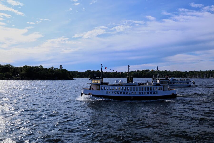 Boats cruising on Stockholm waters with city skyline