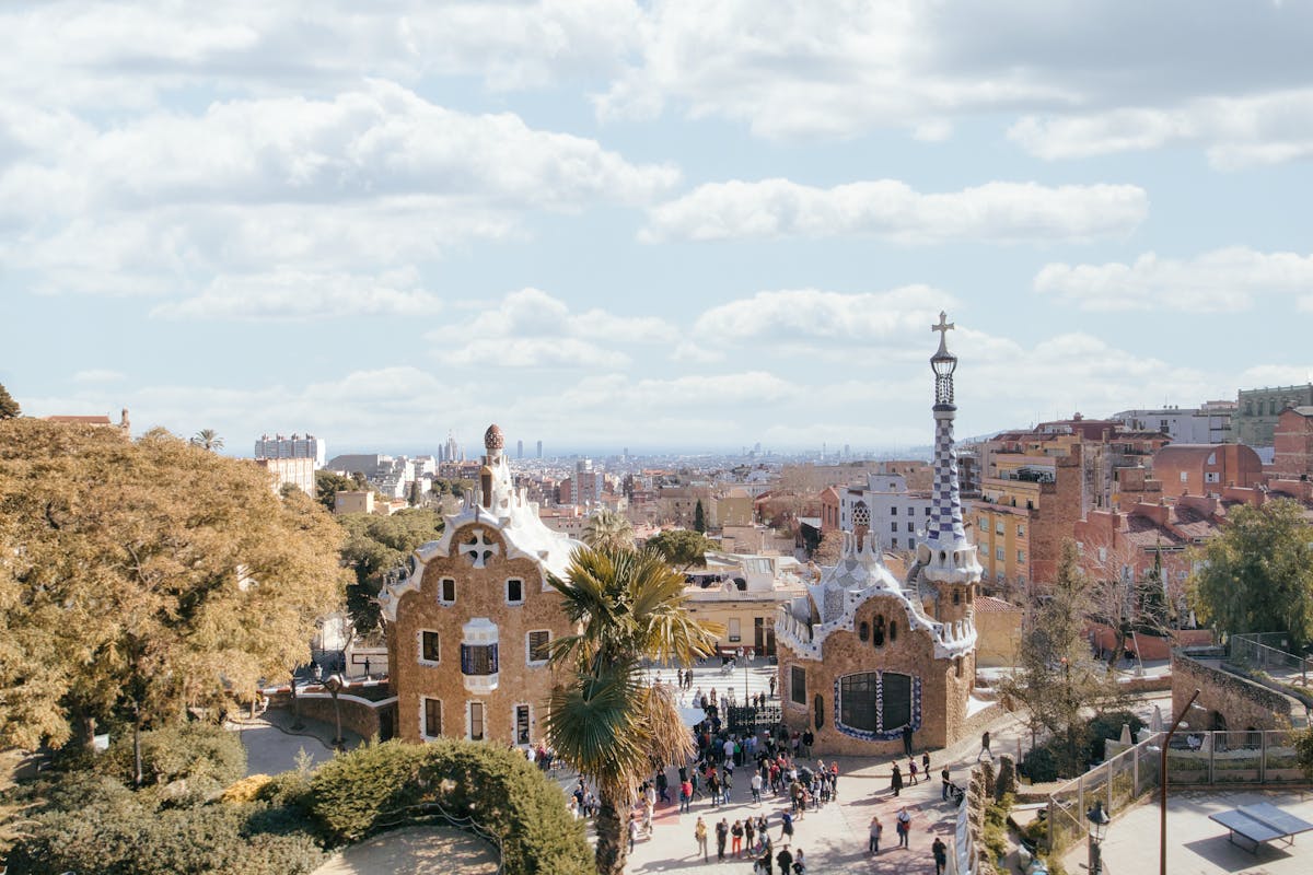 Aerial view of Park Guell with visitors exploring the colorful grounds