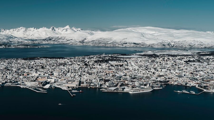 Aerial view of snowy Tromso surrounded by fjords