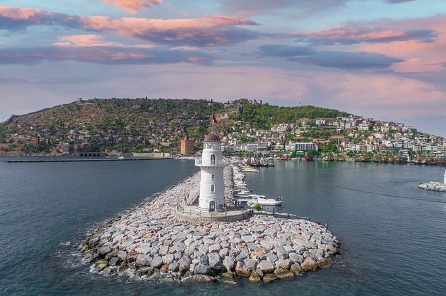 Alanya lighthouse and port with mountains behind