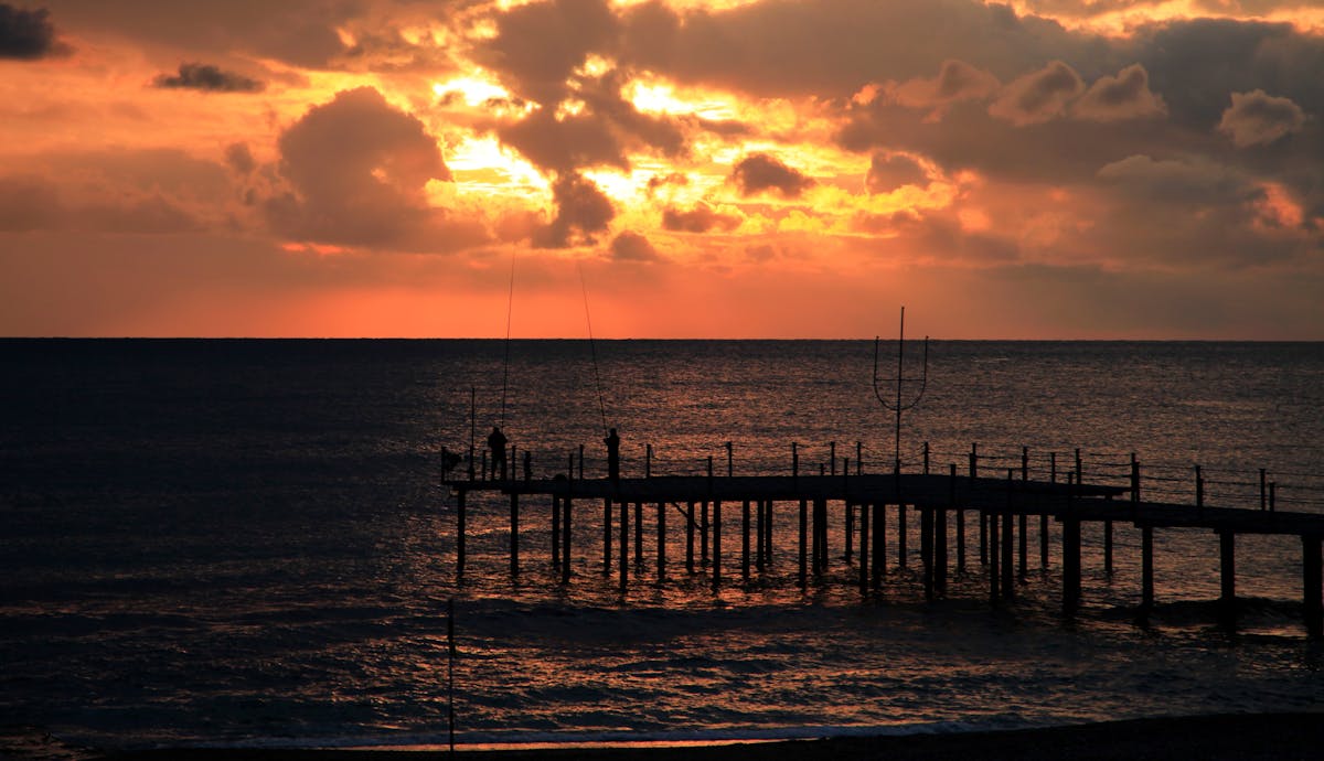 Sunset over the pier and sea in Alanya