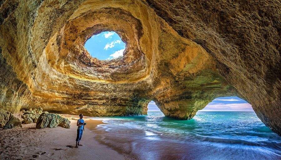 Benagil Cave interior viewed from sea level showing the domed ceiling and sky hole