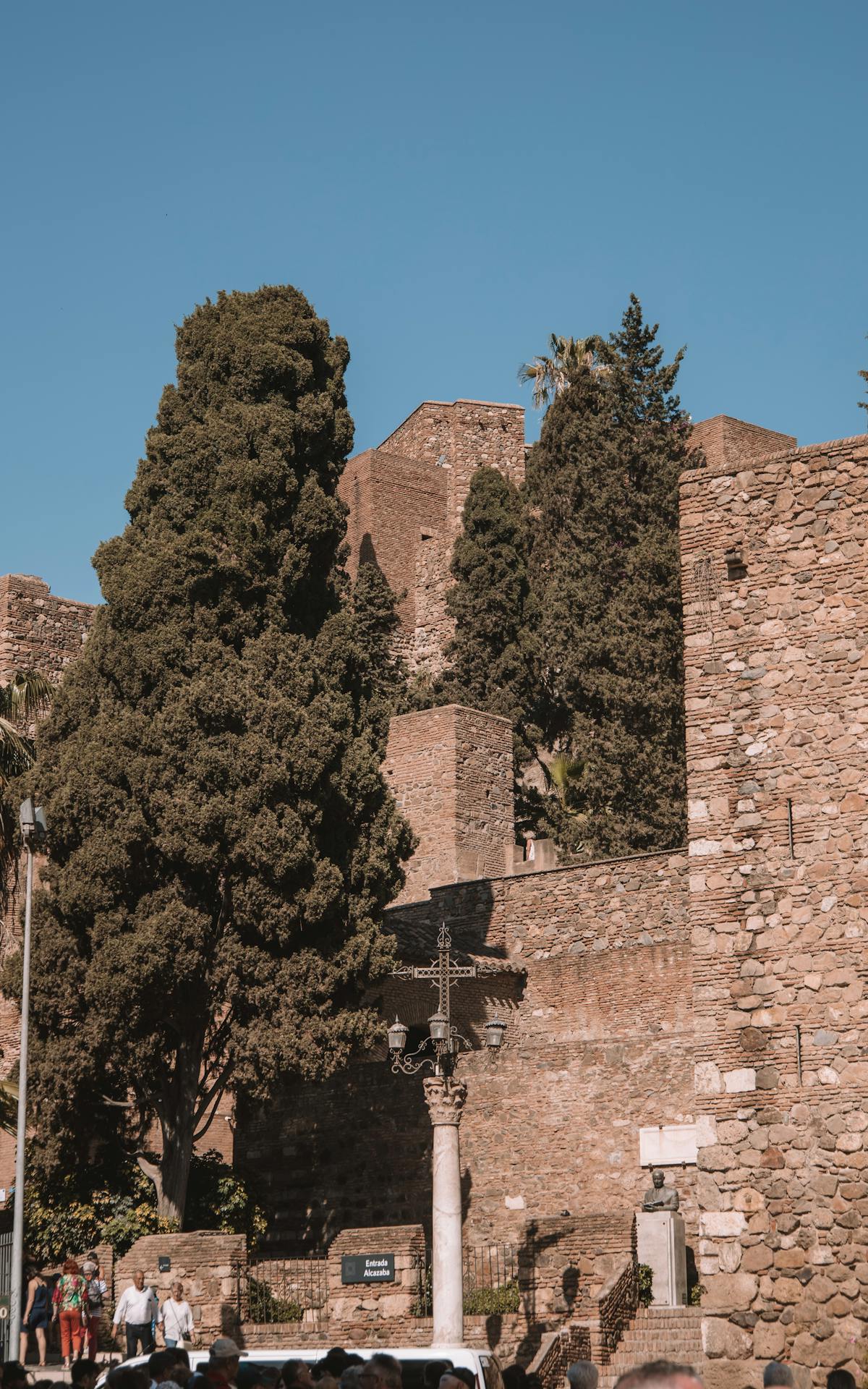 The historic Alcazaba fortress in Malaga with its distinctive walls and towers under a bright blue Andalusian sky