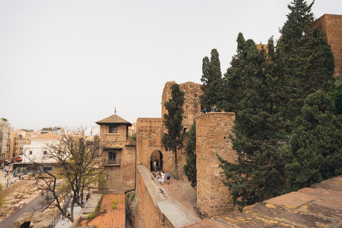 The Alcazaba fortress in Malaga surrounded by lush green gardens and ancient walls