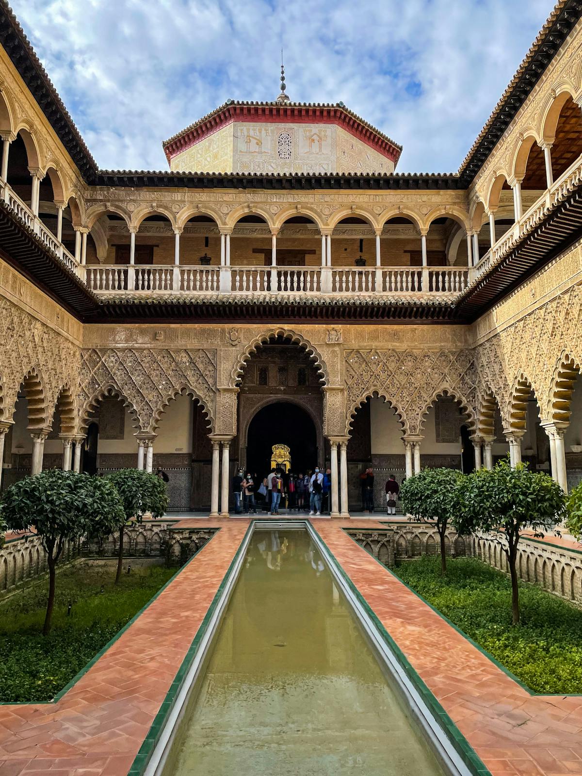 Arched gallery and pool in the Alcazar courtyard