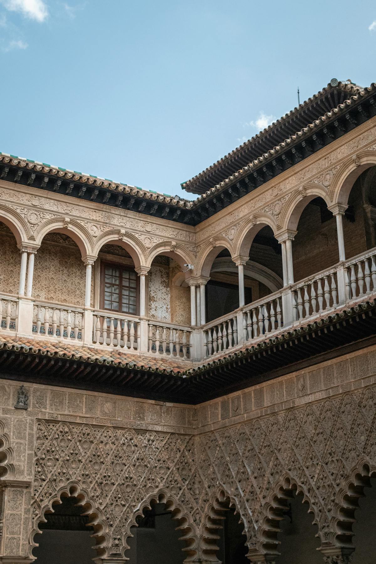 Intricate wall carvings and tilework inside the Royal Alcazar of Seville
