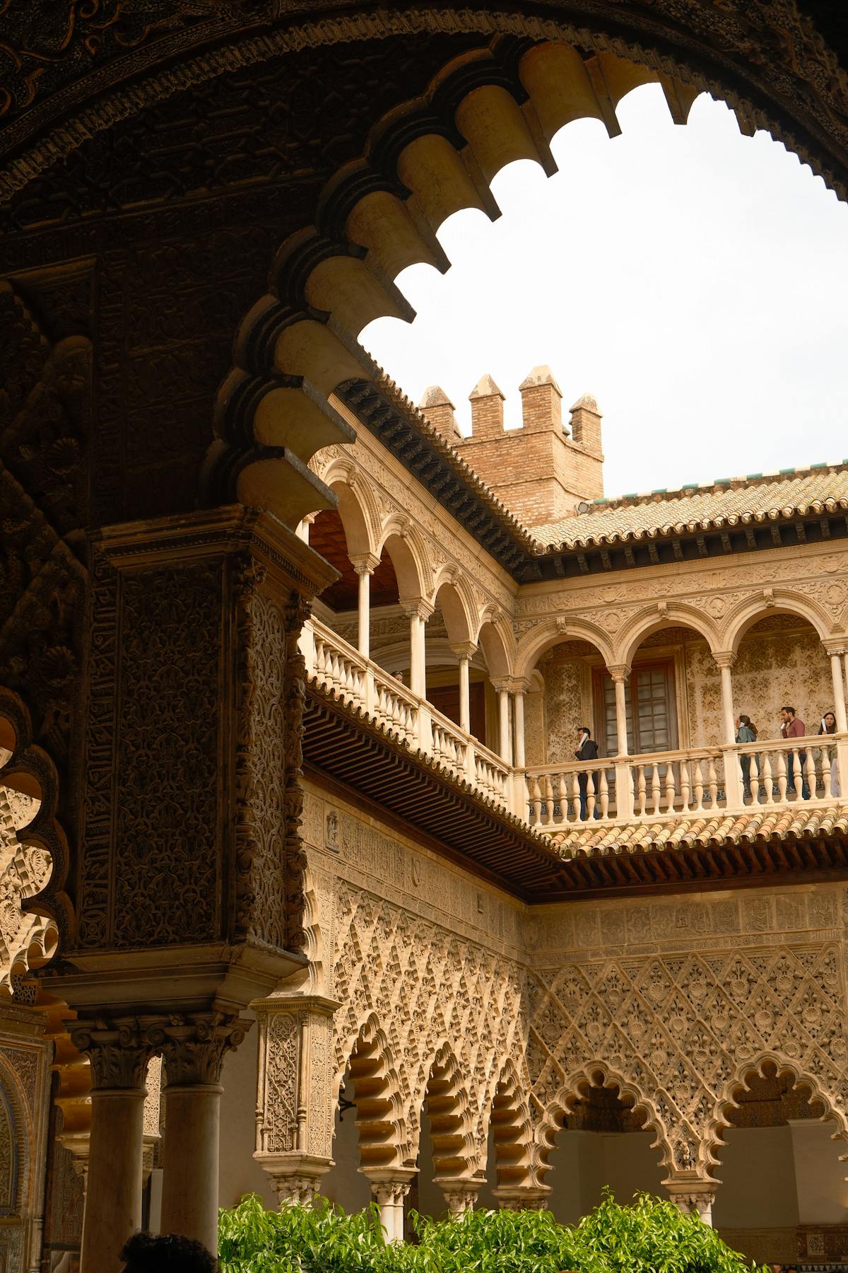 Ornate stone arches and detailed carvings inside the Royal Alcazar of Seville