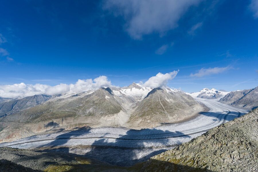 Mountain glacier landscape in the Swiss Alps with snow-covered peaks and blue sky