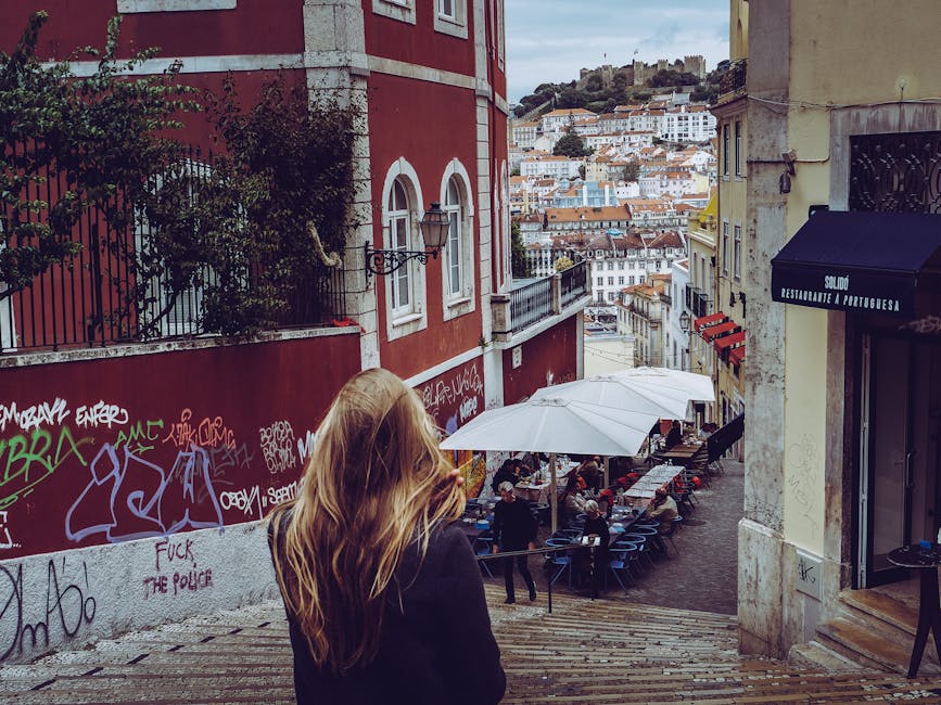 Narrow graffiti-lined stairs in Alfama, Lisbon