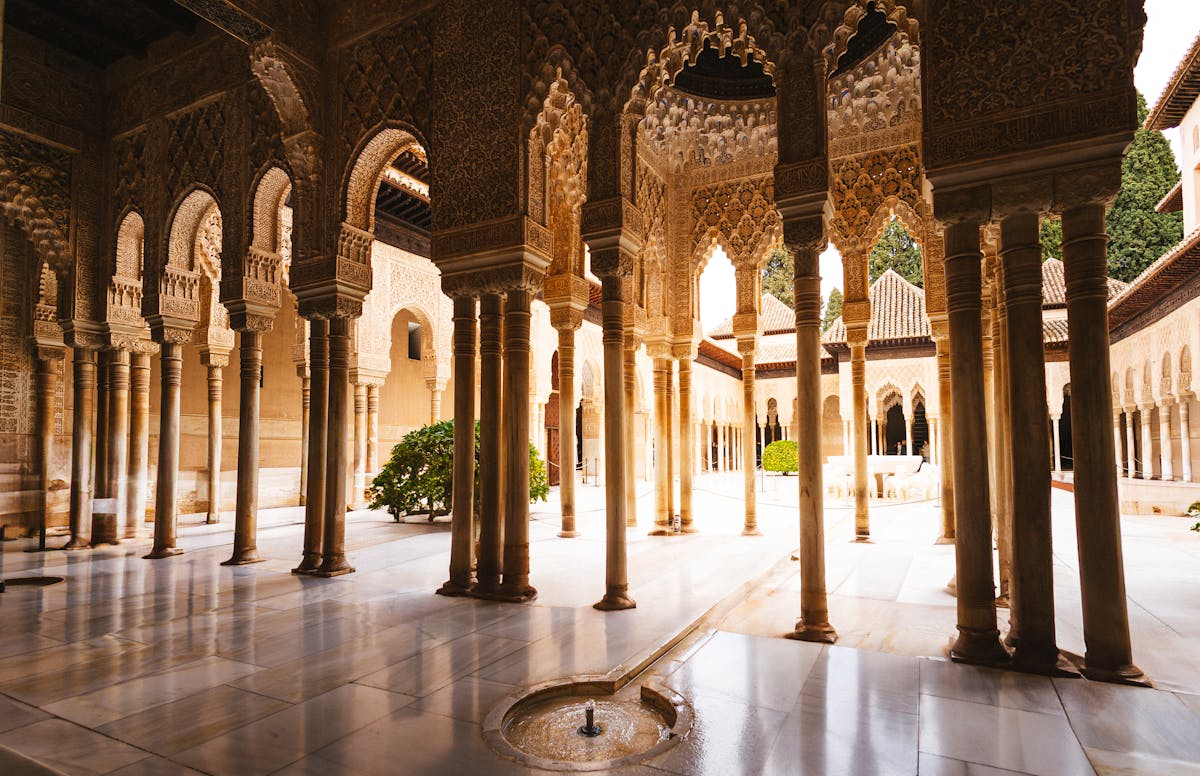 Intricate arches and slender columns inside the Alhambra palace courtyard